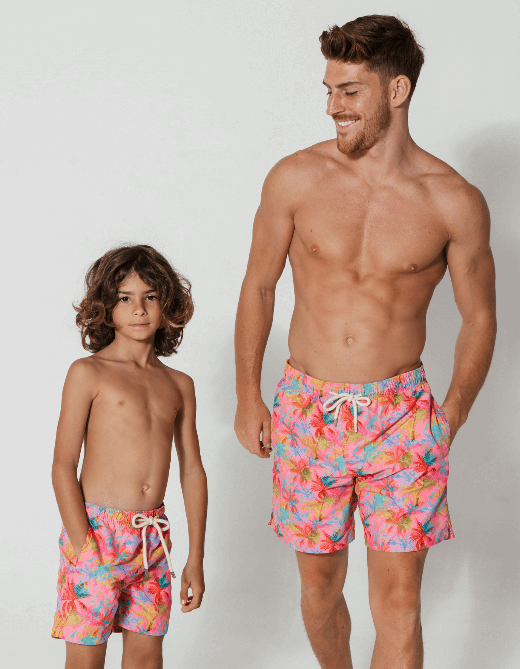 father and son swim shorts pink palm